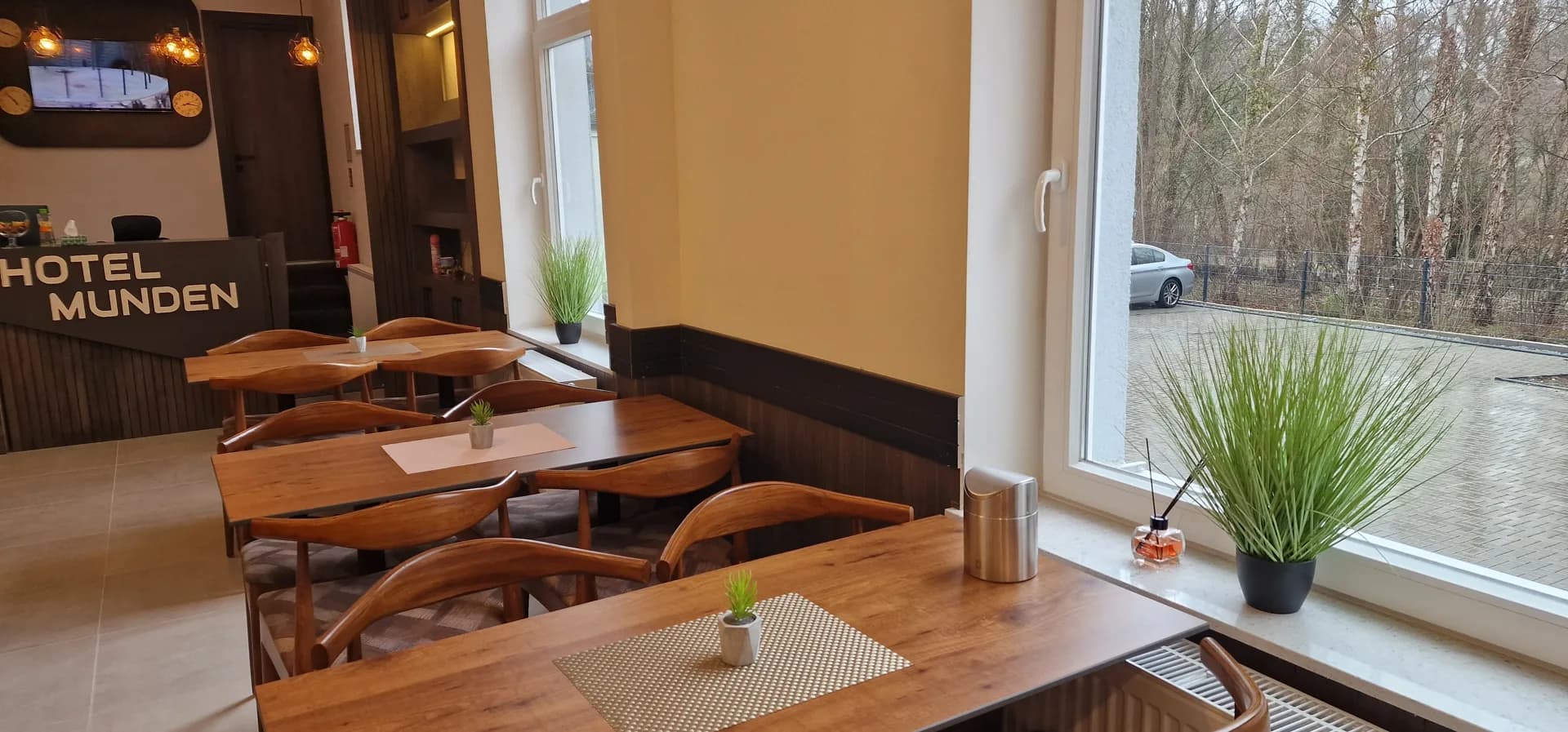 Breakfast room at Hotel Münden with window front and logo lettering